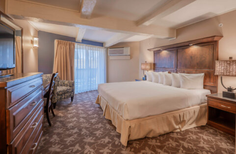 Lakewood Coastal King guest room at Lake Lawn Resort, shown here with two queen beds and a private balcony