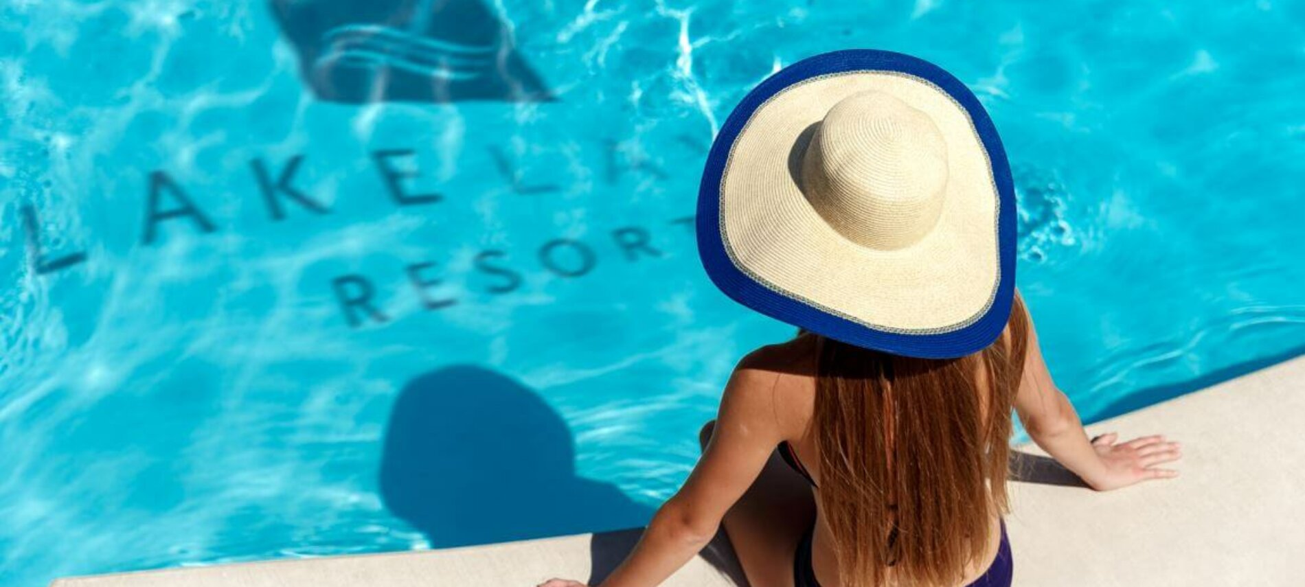 Woman sitting alone by a pool.