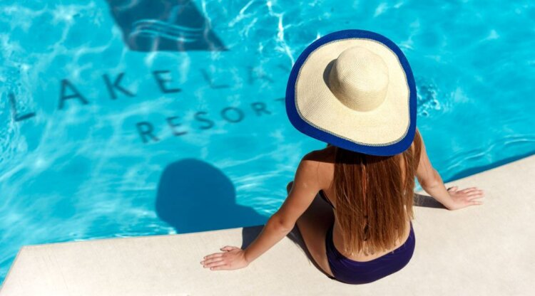 Woman sitting alone by a pool.