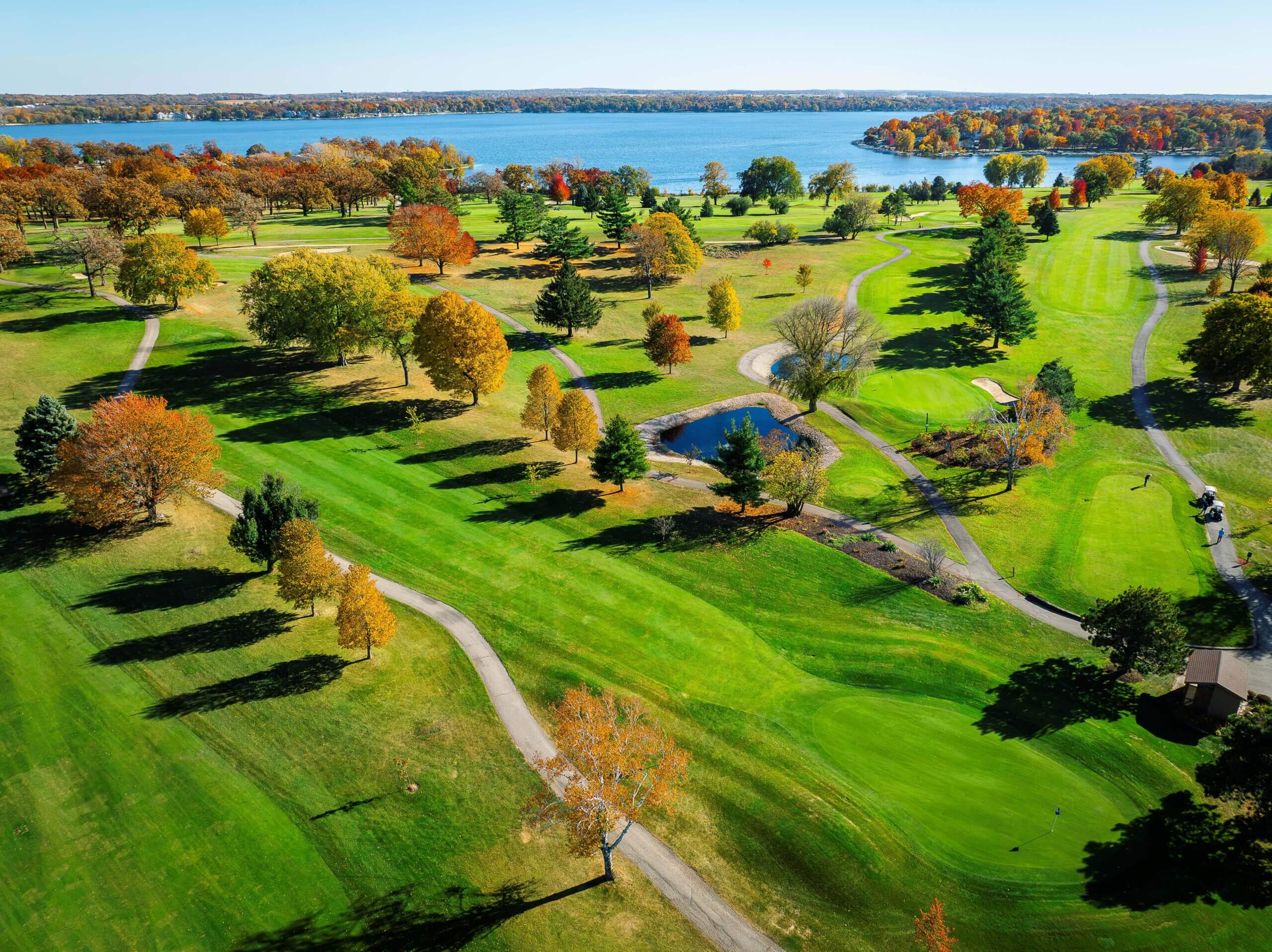 Aerial view of the Majestic Oaks golf course at Lake Lawn Resort in autumn, with fairways and trees along the Delavan Lake shoreline