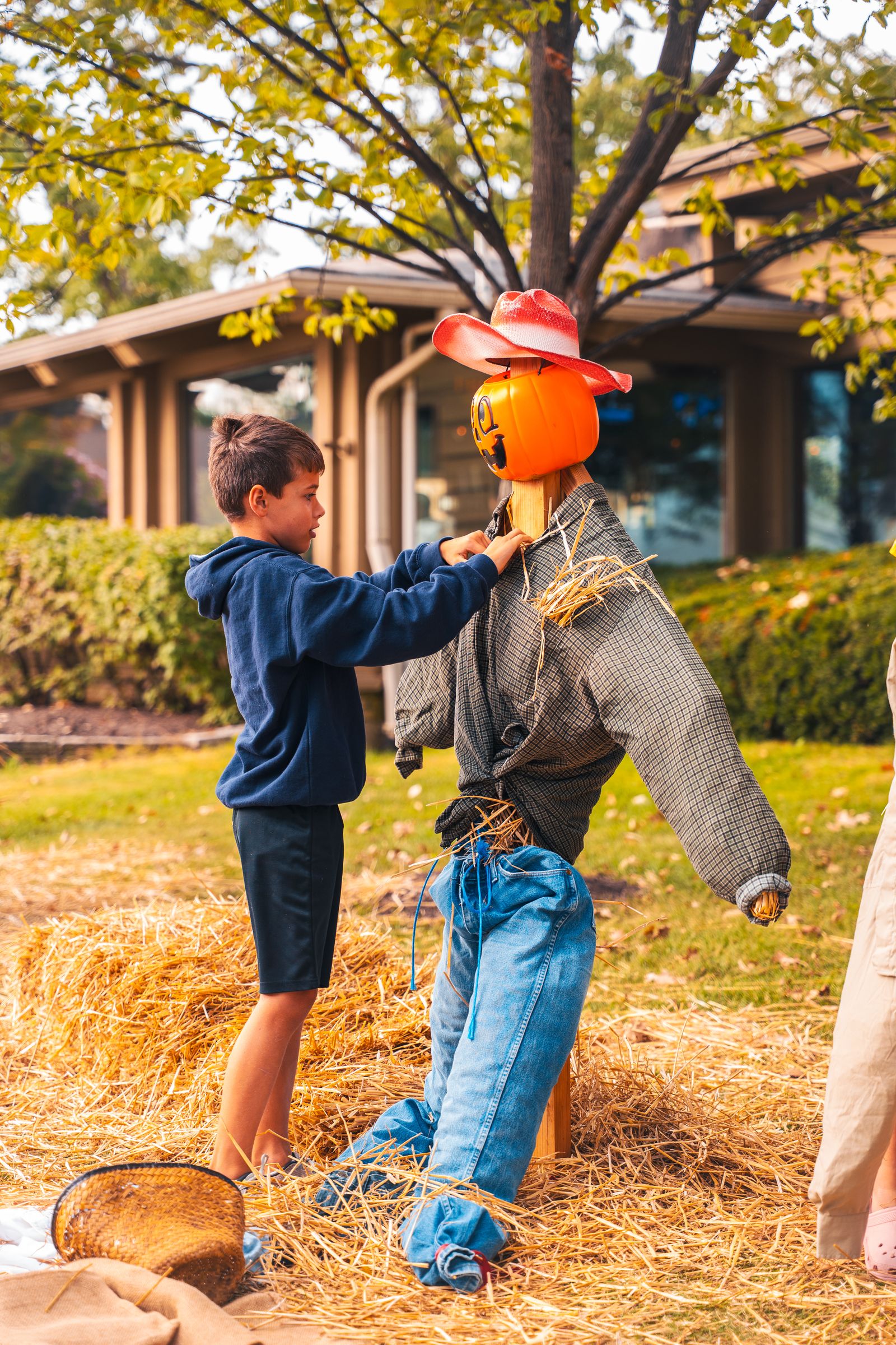 Boy building a scarecrow at the Family Fall Festival